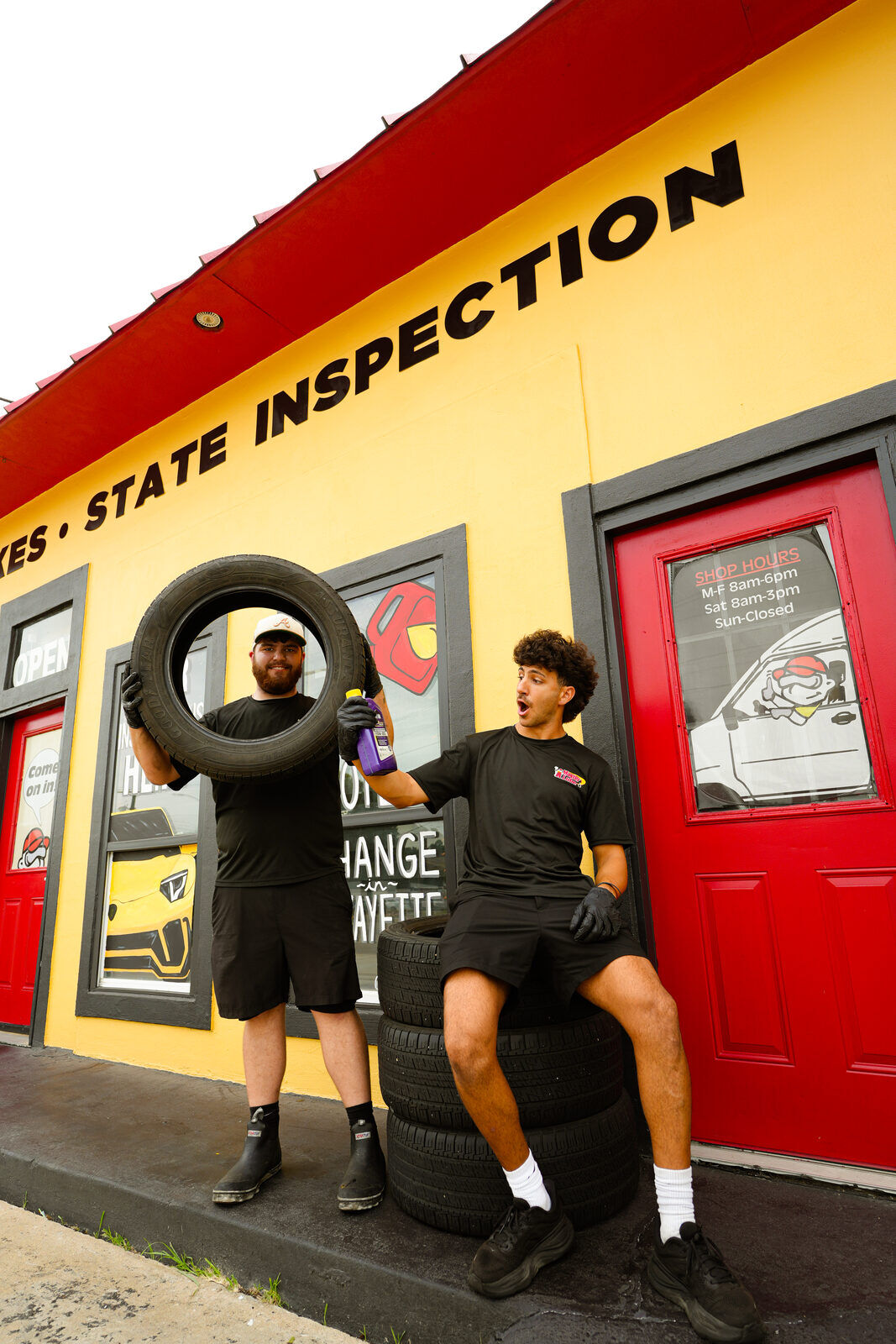 Master Lube team members posing outside the shop storefront
