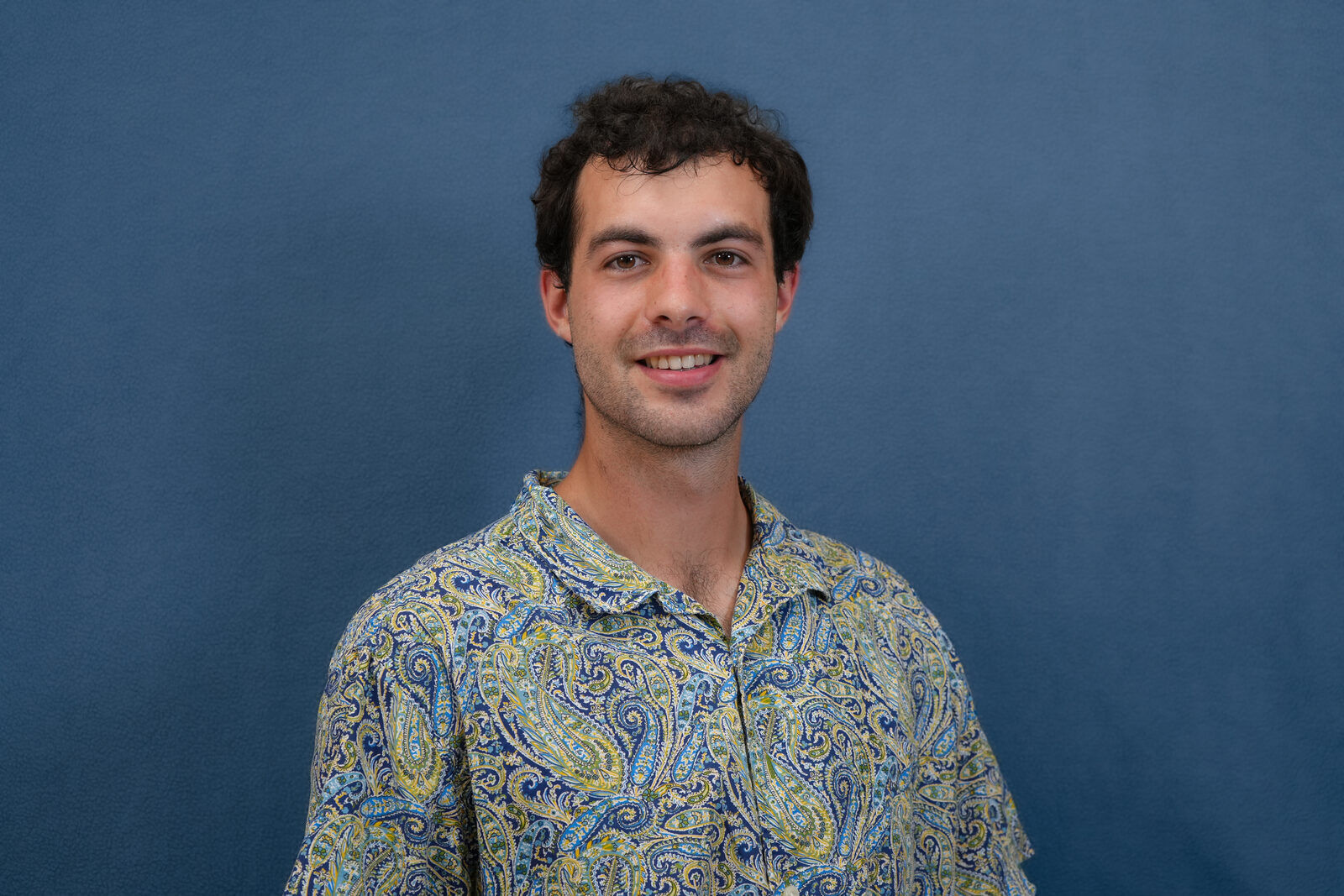 Studio headshot, male subject, patterned shirt